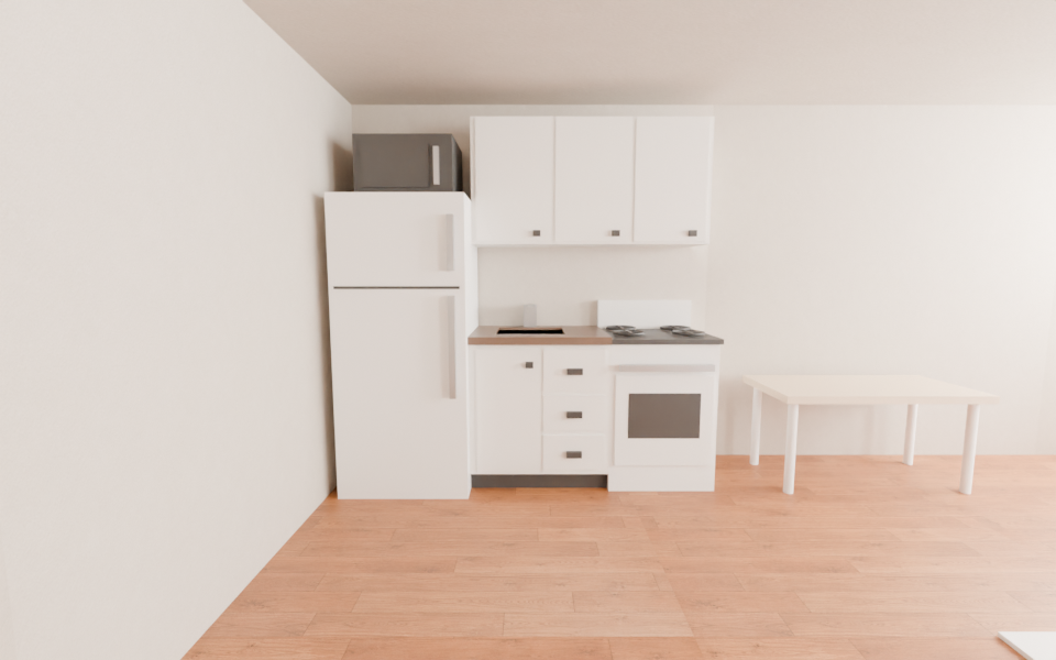 Kitchen build with fridge, sink, and stove